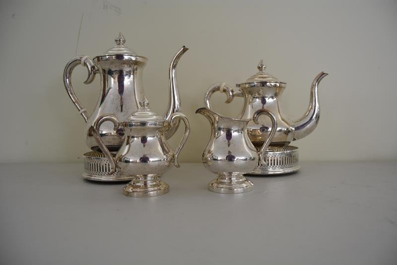 Sterling Silver: Sterling silver tea and coffee service, 2 sterling pitchers, sterling cream and sugar and 2 pitcher coasters. Marked sterling on bottom. Total weight of sterling is 51.68 T Oz