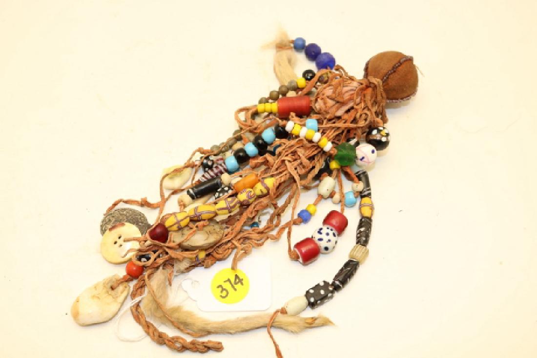 Rock medicine bundle: Rock medicine bundle, many different type beads, Ermine tails, Elk tooth, beaded medicine ball
