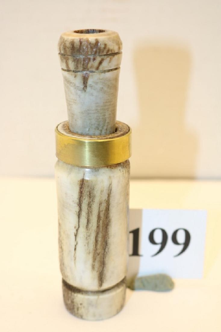 hand-made elk horn barrel/stopper duck: Impressive 5 1/8" hand-made elk horn barrel/stopper duck call by unknown maker. Call features an inserted cedar tone board with single plastic reed and a cedar wedge. This unusual call also features a