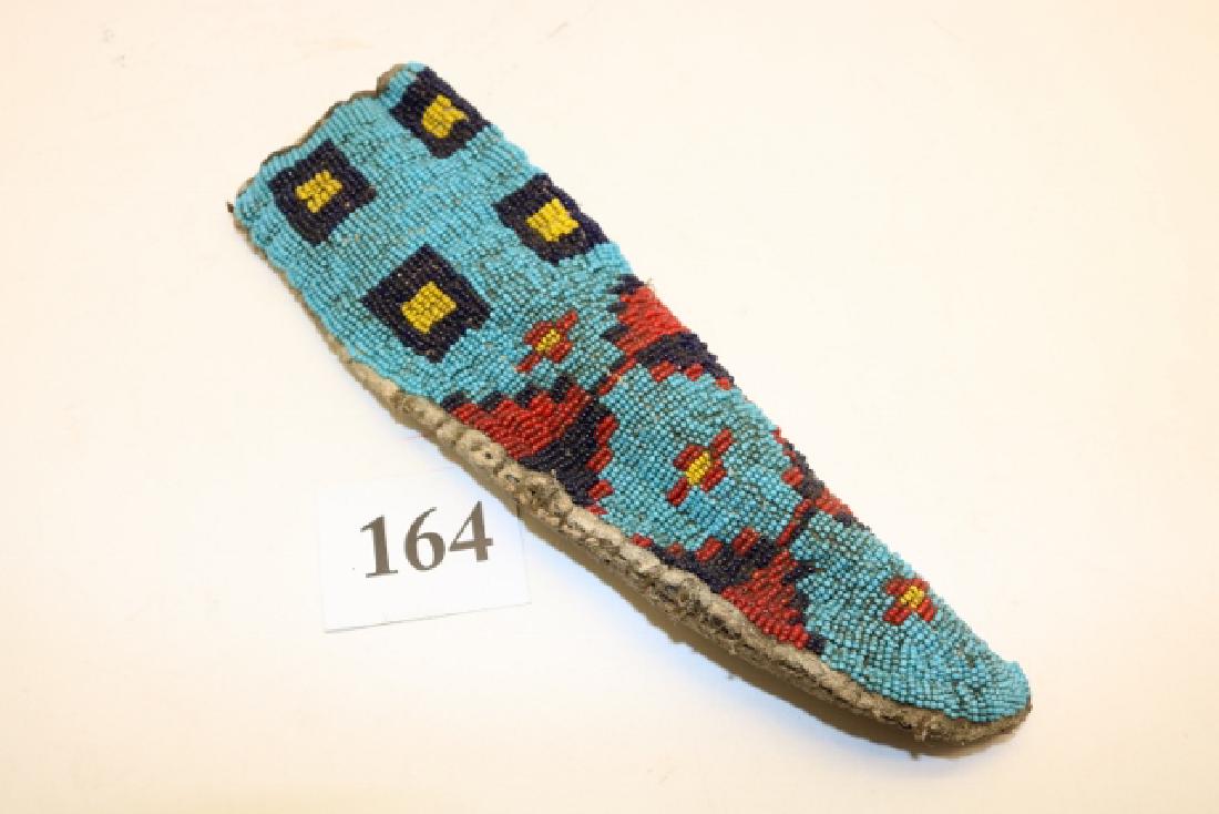 Sioux Beaded Knife Sheath: 9 1/2" x 3" Sioux Beaded Knife Sheath, well used, sinew sewn and beaded, thin rawhide liner, 19th century, stiff