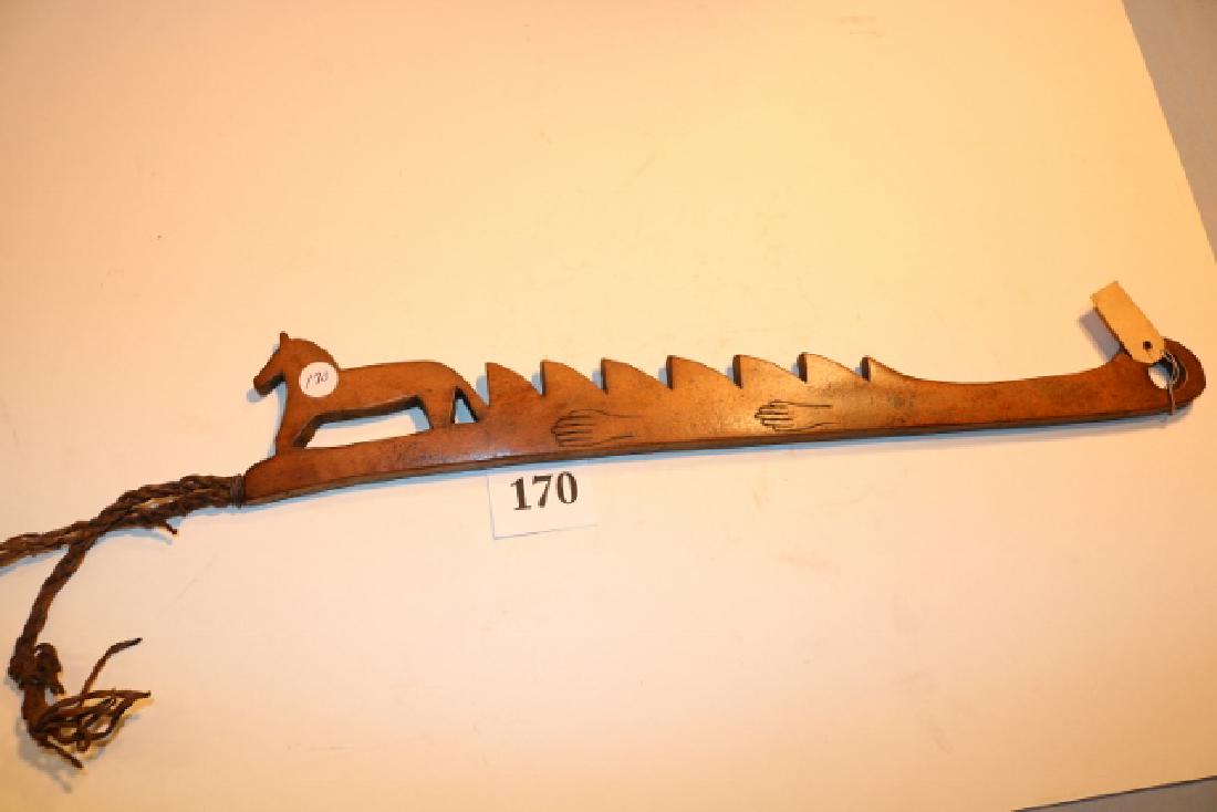 Carved Wooden Quirt: 20" x 3" Carved Wooden Quirt, horse effigy, saw tooth style, large hole for wrist, braided leather quirt at top, 2 carved hands on one side and curved arrow on reverse