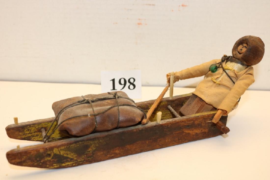 Carved Wood Dog Sled: 10” x 4” Carved Wood Dog Sled with Eskimo Doll, maker signed