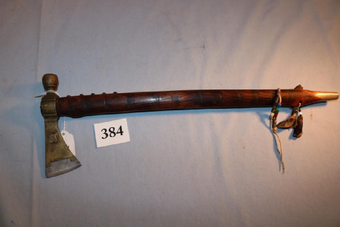6 ¼” Brass Tomahawk: 6 ¼” Brass Tomahawk with steel inset, bit brass tack decorate Flame burnt wood stem, pewter inset mouth piece, antler tip drops with trade beads