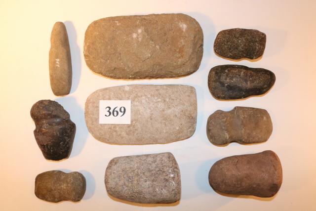 Box Lot of Assorted Stone Tools: Box Lot of Assorted Stone Tools – 10 Stone Items – 2 Manos, 2 Ohio Pestles, 6 Grooved Stone Axes – Smallest Axe 3 ¾” Long, Largest Stone Mano is 8” Long