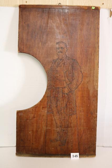 Teddy Roosevelt Full Standing Image: Teddy Roosevelt Full Standing Image in Flemish Art style appears on 19 ½" x 37" wood writing board - aged - darkened - displays very good - unique