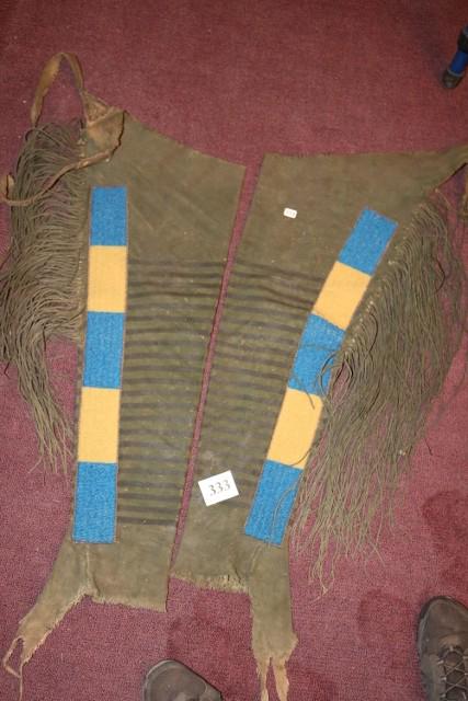 Pair of Hide Leggings: Pair of Hide Leggings, dyed green, wide, long beaded strips, heavily fringed
