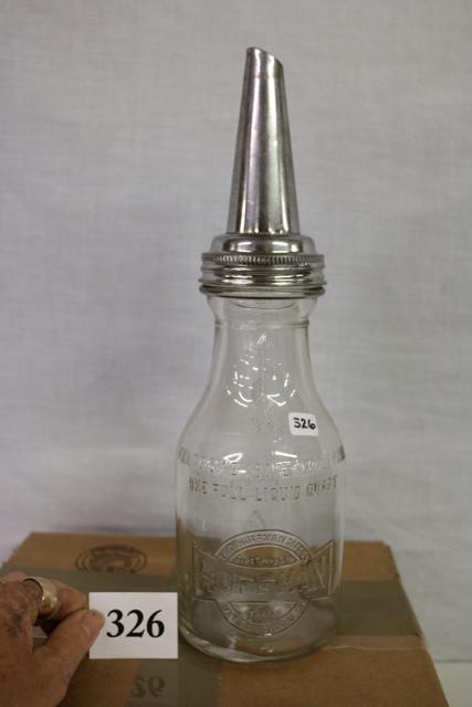 1 quart Huffman motor oil bottle with metal spout some: 1 quart Huffman motor oil bottle with metal spout some surface rust on spout.