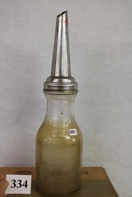 1 quart Huffman motor oil bottle: 1 quart Huffman motor oil bottle with metal spout some surface rust on spout.