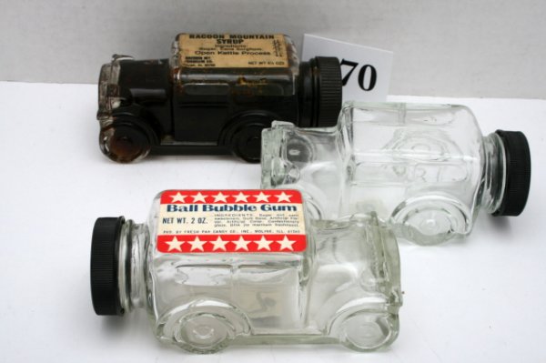 3 Automobile Candy Containers: n/pic - (3pcs)"1929 Model Glass Car" - 1 - Ball bubble gum sticker - no contents - 1 - racoon mountain syrup - hardened contents - 1 - no sticker - all have black plastic caps