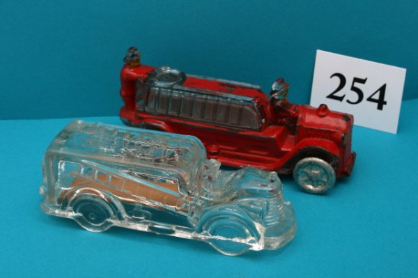 2 Fire Engine Candy Containers: n/pic - (2pcs)Fire Engine - "Fire Dept. in Circle" - T.H. Stough original closure - O/C Fire Engine - "Ladder Truck" - One set original wheels - engine painted red - one set wheels replaced - R/C