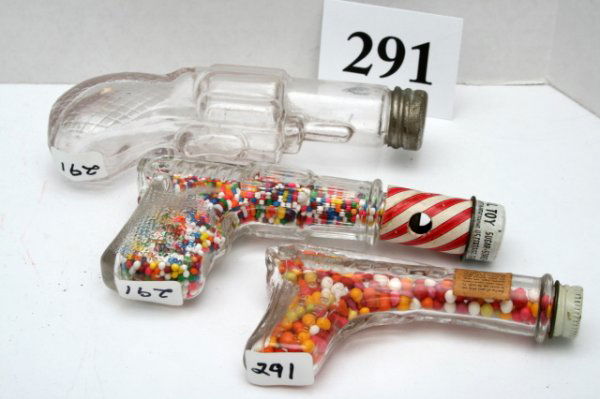 3 Gun Candy Containers: n/pic (3pcs)Gun - "Stough's Whistling Jim" Waisted Grip - Replaced cap - contents not original Gun - "Stough's Three Dot" - No stripped tube - no whistle - O/C Gun - "Small Revolver # 1" - O/C