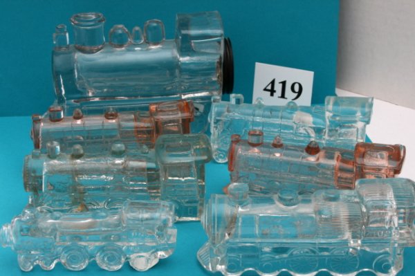 7 Locomotive Candy Containers: n/pic - (7pcs)Locomotive - "Single Window 888" - Chips top and back of cab roof - N/C Locomotive - "Single Window 888" - (2) Pink Taiwan reproductions Locomotive - "Double Window 888" - large chunk le