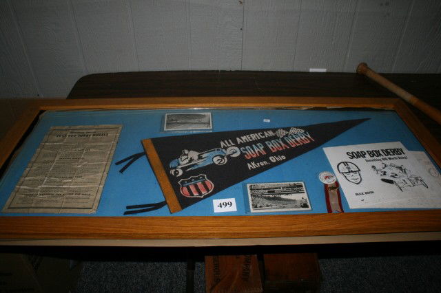Framed Soap Box Derby Display: 22" x 49" Framed Soap Box Derby Display – Firestone Wheel Instructions – Felt banner of Akron, Ohio – 2 Post cards, Akron, Ohio – Rule Book & badge