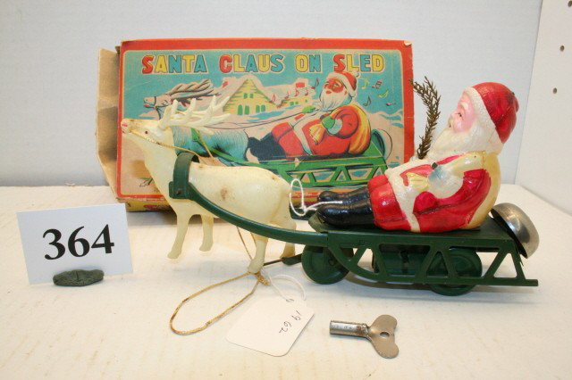 Santa Claus on Sled: Celluloid and Tin Santa Claus on Sled with original box has – key nice condition