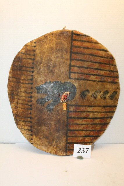 Bear Clan Heavy Rawhide Shield: 15” Painted Bear Clan Heavy Rawhide Shield – painting shows Flying Bullets, Bear Paws and raging Bear- Brain Tanned strapped handles, Rawhide lacing on back 1880’s