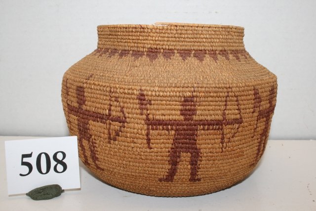 Tightly woven Basket: 7” x 4 ¾” Tightly woven Basket – with dancing Indian Figures with bow and hawk, tribe not identified