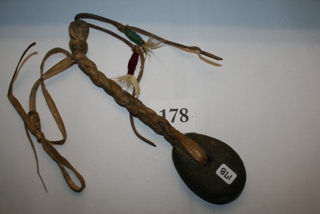 Stone Head Slapper Club: 12” Stone Head Slapper Club – braided rawhide – hafted – feather and cloth drops – early