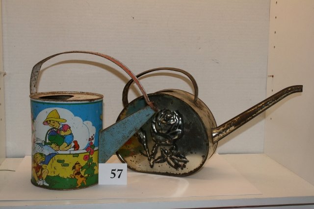 (2) Watering Cans: 8 ½” Tall (2) Watering Cans – rusty – US Metal Toy – other metal with rose (unmarked)
