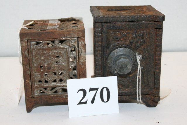2 Cast Iron Banks: 2 Cast Iron Banks – 3 3/8” x 2 ½” “Safe” Bank with key – rusted Pat’d 1886 & 3 ¾” x 2 5/8” “Angel” (on top) Combination Bank – rusted