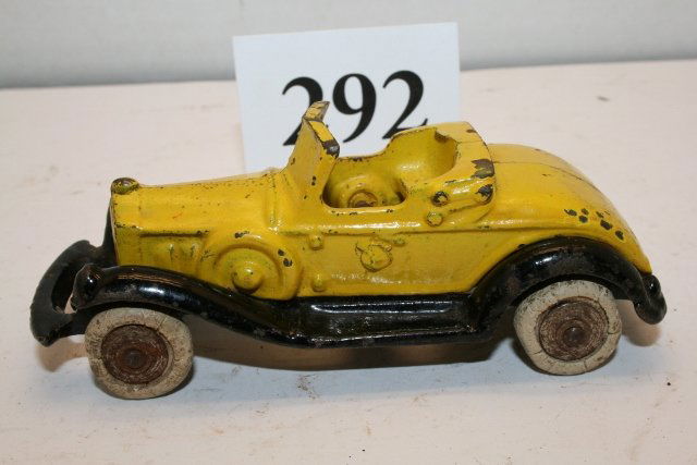 Cast Iron Take Apart Convertible: 4 3/8” A C Williams Cast Iron Take Apart Convertible – yellow body and black frame with some chips – average shape