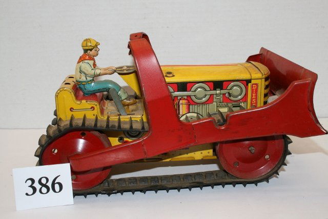 Metal Diesel Caterpillar Bulldozer: 10 ½” Metal Diesel Caterpillar Bulldozer by Marx – good track – some wear to paint – missing hood ornament and back rest – metal support of shovel broken from hydraulic arm (needs soldered)