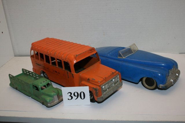 3 Toy Vehicles: 3 Toy Vehicles – 2 Metal Trucks by Tootsie Toy Delivery Truck and a 9 ¼” Orange Bus by Hubley – average shape – 3rd vehicle blue plastic wind up car by Saunders Tool & Die Co. – average sha