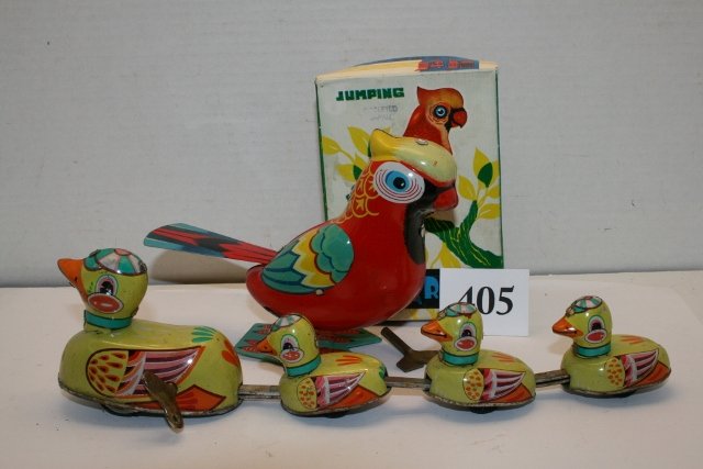2 Tin Wind Up Toys: 2 Tin Wind Up Toys – Duck pulling 3 Ducklings – partially rusted – 5 ¾” Jumping Parrot (like new) in original box – made in Occupied Japan