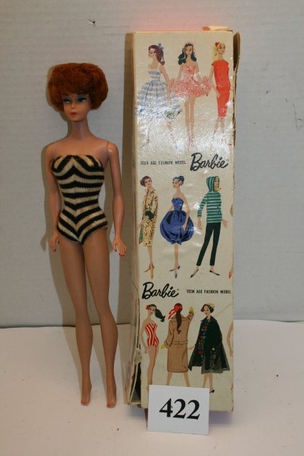 1958 Barbie in Box: 1958 Barbie in Box Bubble Cut hair – one piece black and white bathing suit (stained) – ears look good – box in rough shape – doll good shape