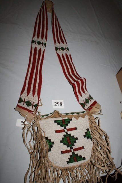Crow Hunting Pouch: 42” x 10” Crow Hunting Pouch – trade cloth over rawhide beaded strap, beaded front on bag