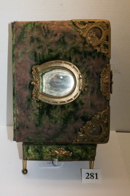 Victorian photo album: Victorian photo album w/ table top holder and drawer, has horseshoes on the cover and a beveled mirror.