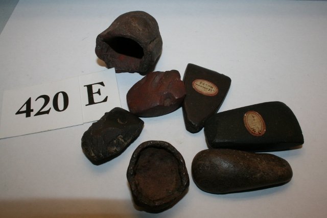 Group of 7 Hematite Artifacts: Group of 7 Hematite Artifacts, 4 are celts, 3 are paint cups, 2 are marked New York State, largest 2 ¼” – nice group – Ex. Trotta – Bono Collection