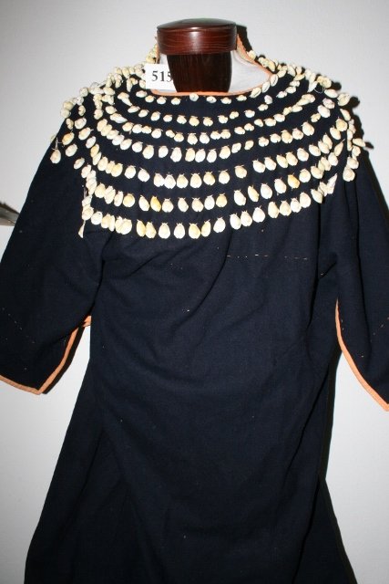 Plains Indian Woman’s Dress: 51 x 37 Good Old Plains Indian Woman’s Dress – Flour bag lining, ribbon decorations on blue trade cloth, with shell decorations – circa 1890- 1900
