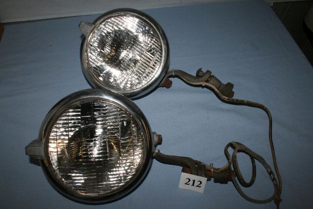 Two Continental (?) head lights: Two matching Continental (?) head lights , have sealed beam bulbs, with mounting bracket. 8” dia. x approx.. 5” deep