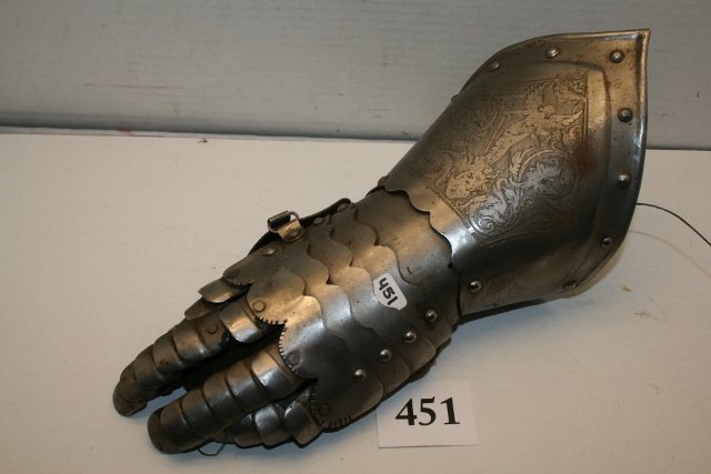 Engraved Armor Guantlet: Engraved Armor Guantlet with articulated finger and hand plates and has Coat of Arms engraved at top, sword of Justice Angel standing over a devil, nicely crafted