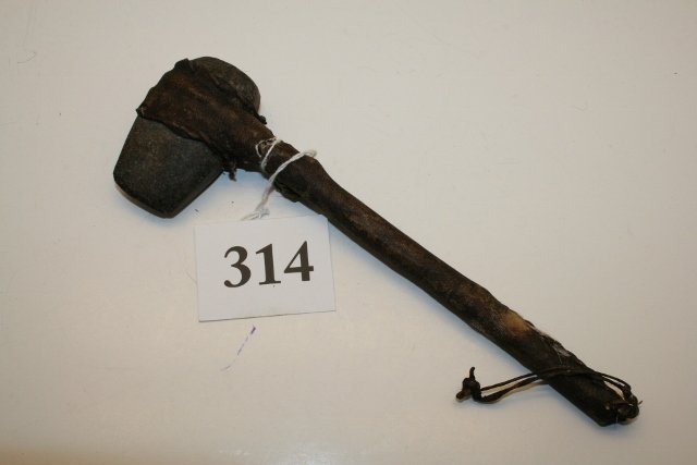 Stone Mini Groove Axe: 2 ½” Stone Mini Groove Axe with 7” hafted handle, hide cover appears to have age, stone authentic