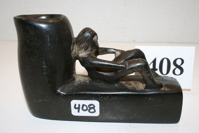 Black Steatite “Woman Giving Birth” Pipe: 4 ½” x 2 ¾” Black Steatite “Woman Giving Birth” Pipe – highly polished, head appears skull like, possibly indicating death at child birth