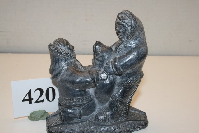 Soapstone Eskimo with seal: 4 1/8” x 4 3/8” Soapstone Eskimo with seal – a Wolf Creation