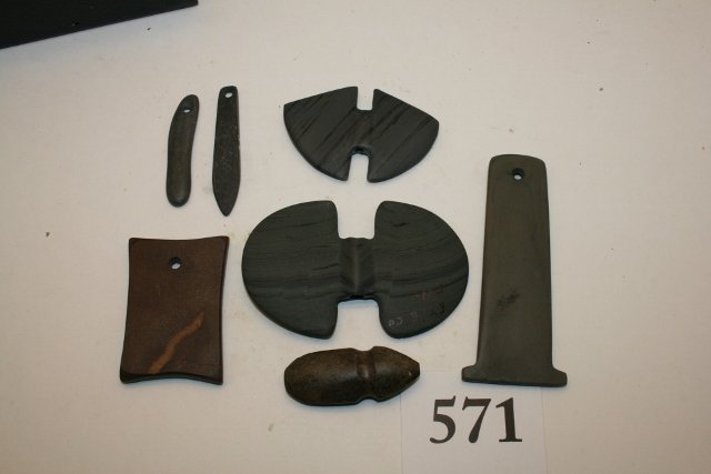 7 Contemporary Miniature Artifacts: Frame containing 7 Contemporary Miniature Artifacts – including 4 pendants, 2 bannerstones, stone axe, largest 3 ½” Ex. Retort Coll.
