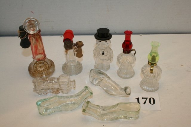 2 Telephones: 2 Telephones, 1 has receiver, no closure, the other has both, 3 glass shoes, small train no closure, 2 small oil lamps with plastic chimneys, man with black plastic hat Candy Containers