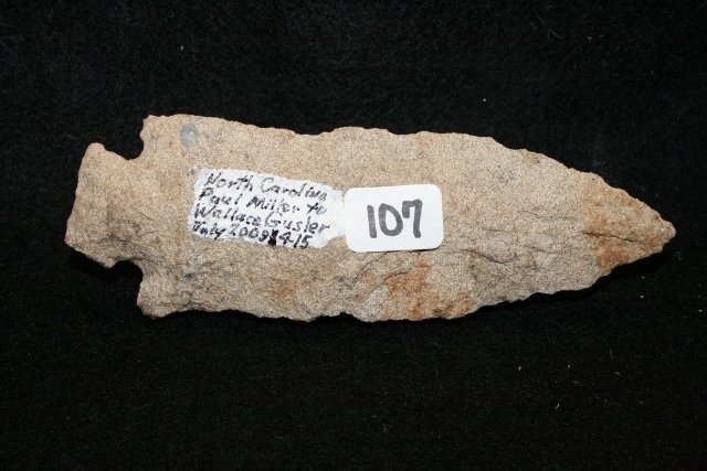 Quartzite Corner Notch Point: 4 ¾” Quartzite Corner Notch Point from N.C. – Ex. Paul Miller, M.M. Deffenbaugh Colls. – old ding to base Wallace Gusler Coll.