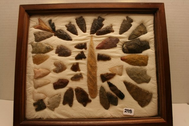 bone awl and 37 Flints: 10 x 12 Wood Frame containing a 4 7/8” bone awl and 37 Flints, some are of Knife River Flint, largest 2 5/8”