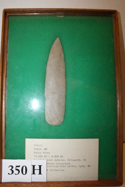 Chert Clovis Point: 6 3/16” Chert Clovis Point, Hobbs N.M. found by Leon Johnson, Ellsworth, KS. Ex. Johnson, Loftis, Siwik Coll. – age uncertain in wood display Frame 8 x 12