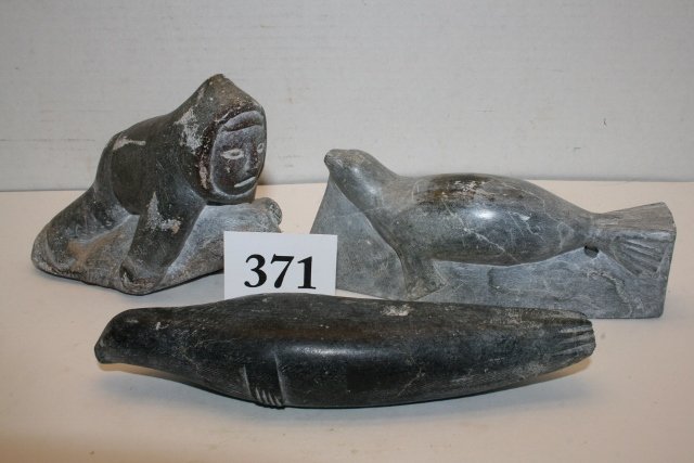 3 carved Soapstone Eskimo: 3 carved Soapstone Eskimo, Canadian Carvings, 2 Seals, Man with seal, some scratches to surface, largest 7”
