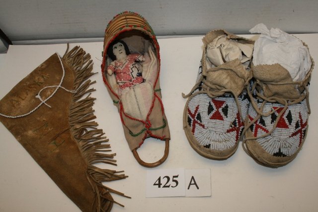 Beaded Childs Moccasins: Lot Consisting of Pair of Beaded Childs Moccasins, 7 ½” long, Child’s Doll Cradle Board with doll and a Hide Fringed Holster from Alaska