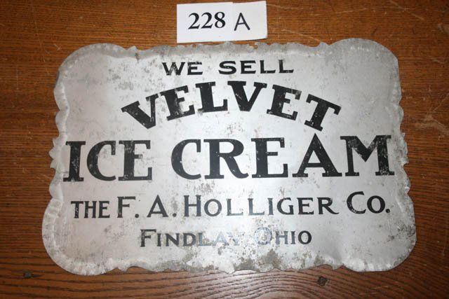 Tin Advertising Sign: Tin Ice Cream Advertising Sign - "We Sell VELVET ICE CREAM The F.A. Holliger Co. Findlay, Ohio" - 11 3/4" long x 8" wide - minor chips on rim on right side