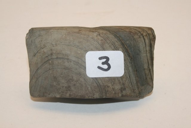 Banded Slate Reel Bannerstone: 2 5/8” Banded Slate Reel Bannerstone – chip at hole – paper in hole reads Wayne Co. Michigan