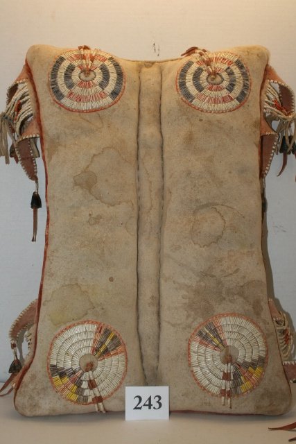Crow Saddle pad: 14” x 18” Crow Saddle pad with fine quilled rosettes, beautifully quilled, fine condition, brain tanned, sinew sewn, dew claw drops, quilled fringe, minor old stains on leather