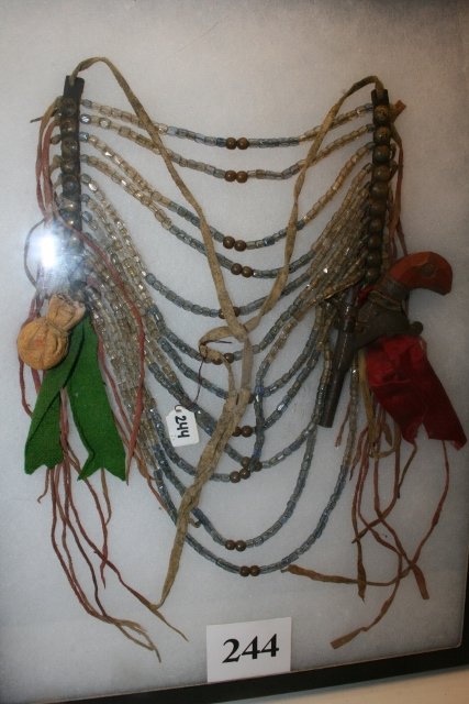 Breast Plate: 8 x 12 (Circa 1890) Breast Plate with Bead Loops/Medicine Bag and small derringer single shot pistol attached – Rare!