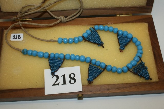 Strand Turquoise Glass Bead: 14” Strand Turquoise Glass Bead with 5 Triangular Leather Tabs inlaid with Turquoise Pony Beads, acquired from a Spotted Tail Woman at Paddock, Nebraska in 1879, Ex. Sam Kacher Coll., sold at Garth�