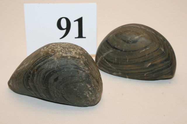 2 Banded Slate Boat Stones: 2 Banded Slate Boat Stones, both scooped out, one has groove on top, the other drilled, one hole broke out, both from Indiana, largest 2 3/8”